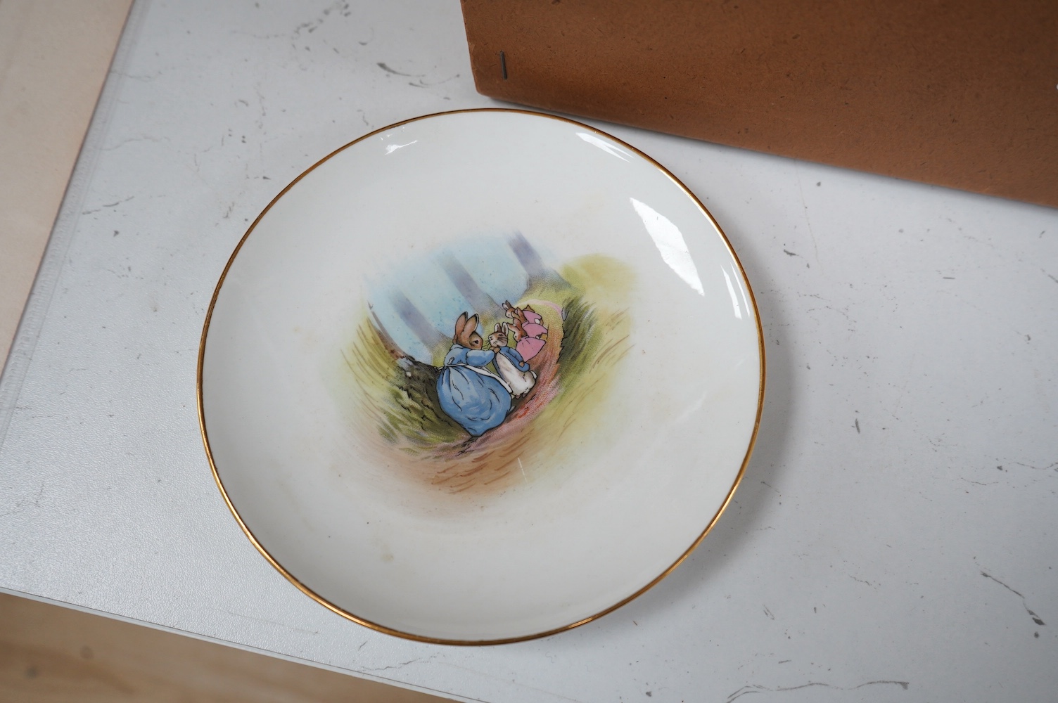 A children’s Beatrix Potter part tea set and other miniature porcelain tableware, largest 15.5cm wide. Condition - fair